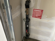 Water Shutoff Example - gate valve on a vertical pipe coming out from a wall in a garage