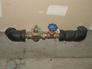 Water Shutoff Example - gate valve on a horizontal pipe coming out from a wall in a garage