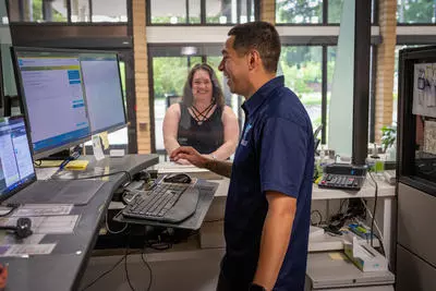 A TVWD employee helping a smiling customer