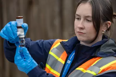 A TVWD employee looking at a water sample