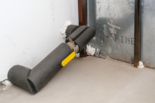 Water Shutoff Example - ball valve on a horizontal pipe coming out from a wall in a garage
